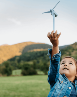 A child holding a small wind turbine