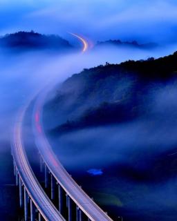 An aerial view of a highway in the fog.