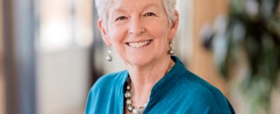 A woman smiling at camera.