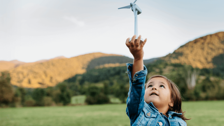 A child holding a small wind turbine