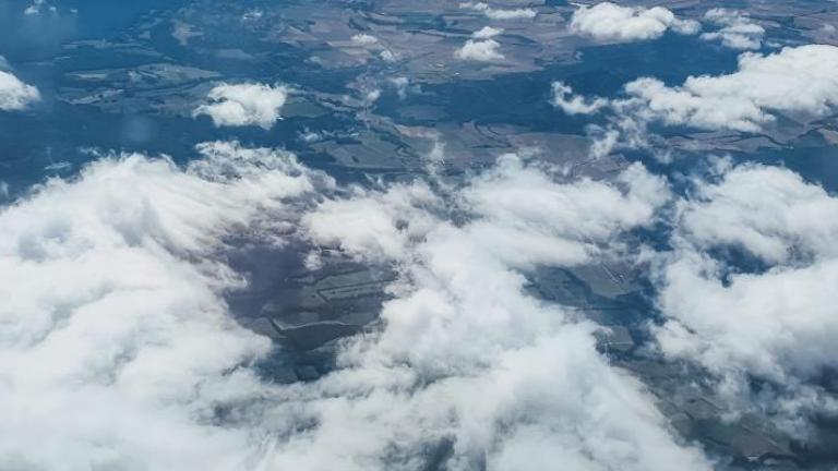A view of clouds from the wing of an airplane.