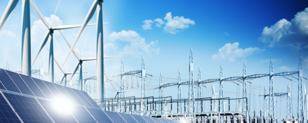 Image shows solar panels, wind mills and a power grid against a blu sky with small clouds