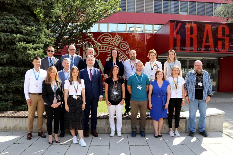 A group of people posing in front of a building.