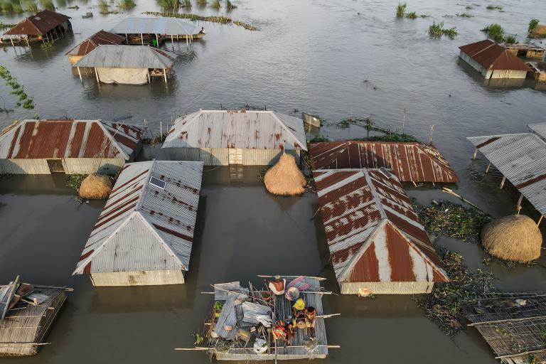 An aerial view of flooded huts in cambodia.