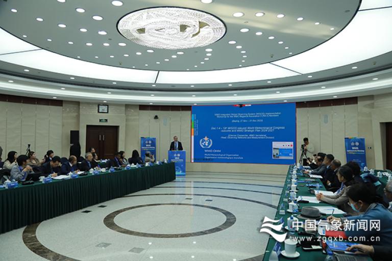 A group of people sitting at a table in a conference room.