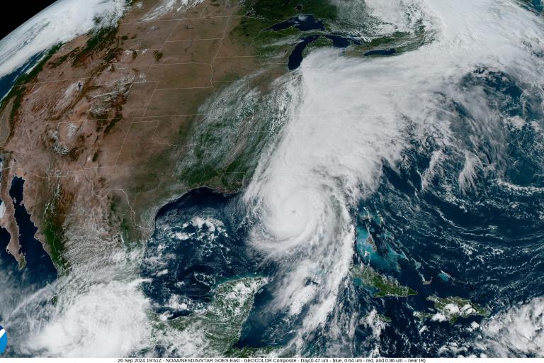 Satellite image of a large storm system over the southeastern United States and Gulf of Mexico, with dense cloud cover and a visible storm eye near the center.