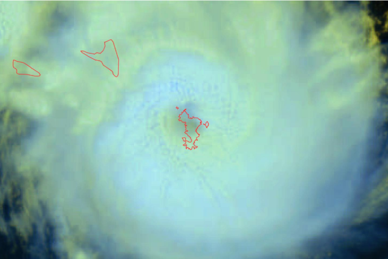 Satellite image showing the eye of a cyclone with swirling clouds around it. Red outlines mark landmasses. Meteo France logo is in the top right corner.