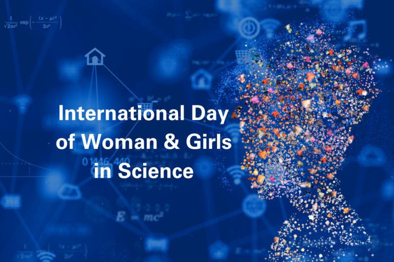 Silhouette of a woman filled with colorful particles against a blue background with text: "International Day of Woman & Girls in Science.