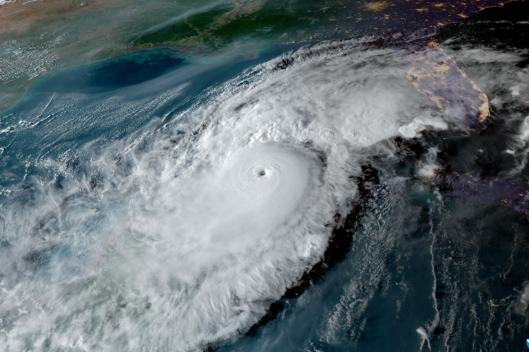 Satellite image shows a large hurricane with a distinct eye over the Gulf of Mexico approaching the southeastern coast of the United States.