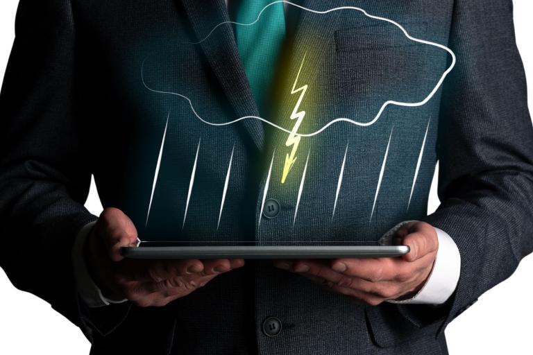 A person in a suit holds a tablet displaying a digital illustration of a cloud with rain and lightning.