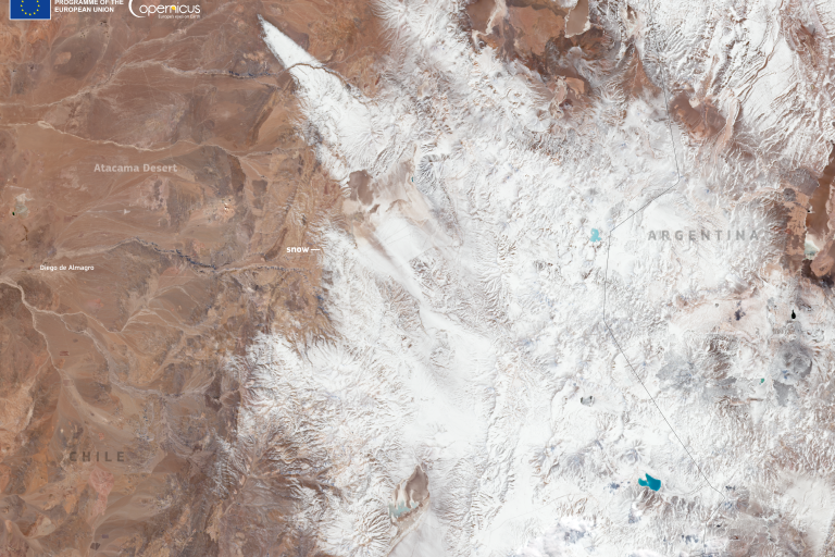 Satellite image showing the snow-covered Andes mountains between Chile and Argentina, with the Atacama Desert visible on the left side of the image. Copernicus and EU logos are present.