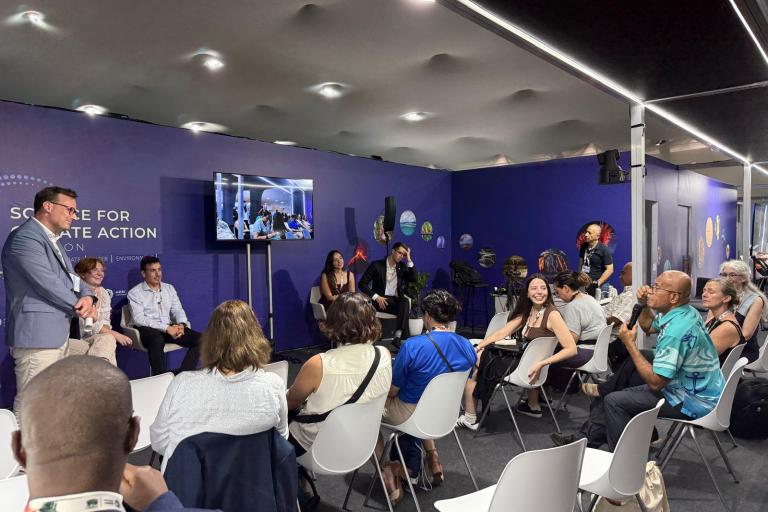 Group of people listening to a session at COP30 WMO Pavilion