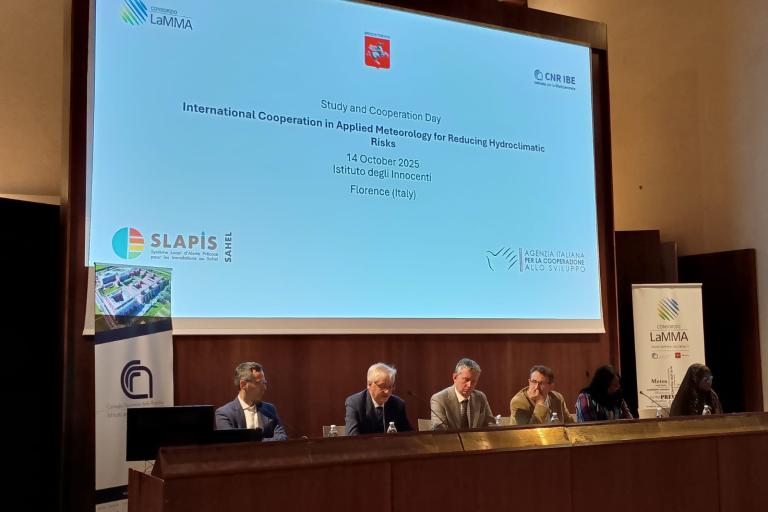 Five people sit at a panel discussion during the "International Cooperation in Applied Meteorology for Reducing Hydroclimatic Risks" event in Florence, Italy, on October 14, 2025.