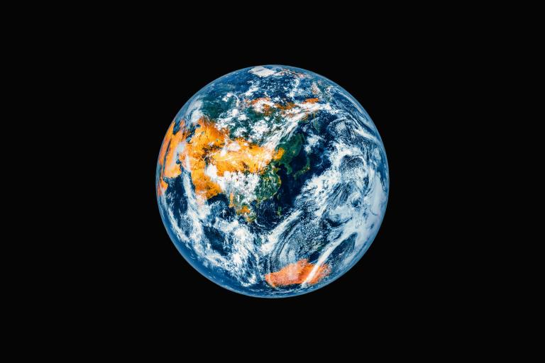 A view of Earth from space showing Asia, Australia, and parts of Europe and Africa against a black background.