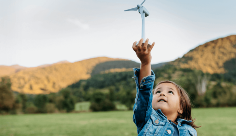 A child holding a small wind turbine
