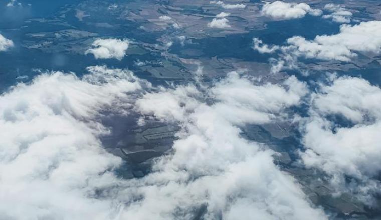 A view of clouds from the wing of an airplane.