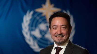 Albert Fischer in front of WMO flag.