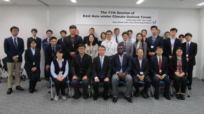 A group of people posing for a photo in a conference room.