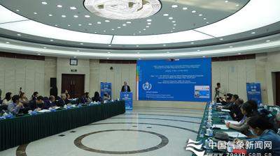 A group of people sitting at a table in a conference room.