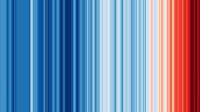 Image of vertical colored stripes transitioning from dark blue on the left to red on the right, representing a data visualization of changing temperatures over a period of time.