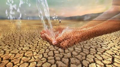 A pair of hands catching flowing water is superimposed over a barren, cracked desert landscape with a solitary person in the background.