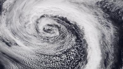 A satellite image of a large cyclone showing a swirling pattern of clouds over the ocean.