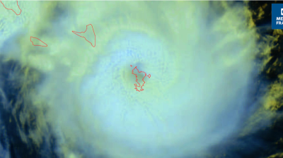 Satellite image showing the eye of a cyclone with swirling clouds around it. Red outlines mark landmasses. Meteo France logo is in the top right corner.