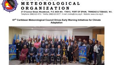 Group photo of the Caribbean Meteorological Organization's 67th council, featuring numerous participants standing and seated, with flags in the background.