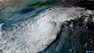 Satellite image shows a large hurricane with a distinct eye over the Gulf of Mexico approaching the southeastern coast of the United States.