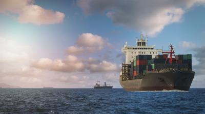 A massive cargo ship navigating the open sea, surrounded by water