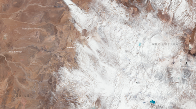 Satellite image showing the snow-covered Andes mountains between Chile and Argentina, with the Atacama Desert visible on the left side of the image. Copernicus and EU logos are present.