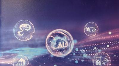 A digital graphic shows a central "AI" icon surrounded by four circular icons representing business, healthcare, engineering, and communication, on a purple abstract background.