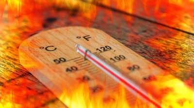 A thermometer shows high temperatures in both Celsius and Fahrenheit, surrounded by flames, suggesting intense heat or extreme temperature.