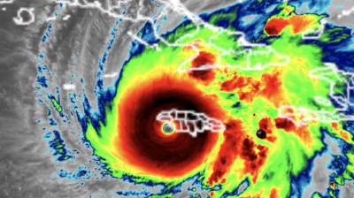 Infrared satellite image showing a large hurricane with a defined eye over the Caribbean, affecting islands including Haiti, Jamaica, and Cuba.