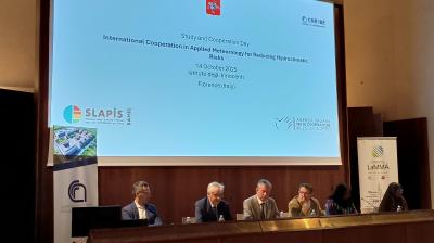 Five people sit at a panel discussion during the "International Cooperation in Applied Meteorology for Reducing Hydroclimatic Risks" event in Florence, Italy, on October 14, 2025.