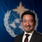 Albert Fischer in front of WMO flag.