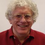 A man wearing glasses and a red shirt.