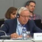 A man sitting at a table with headphones on.