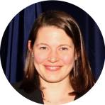 An image of a woman smiling in front of a blue background.