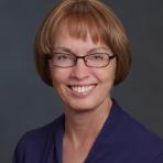 A woman wearing glasses and a purple shirt.