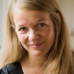 A woman with long blonde hair smiling for the camera.