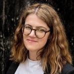 A woman wearing glasses and a t - shirt.