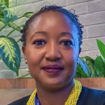 A woman in a black shirt with a yellow necklace.