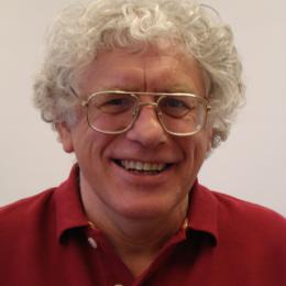 A man wearing glasses and a red shirt.