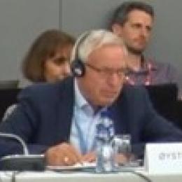 A man sitting at a table with headphones on.