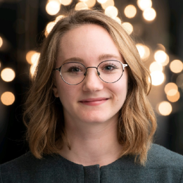 Brianna Lazerwitz smiling in front of lights.