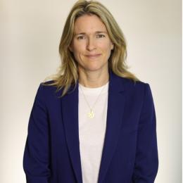 A woman wearing a blue blazer and white shirt.