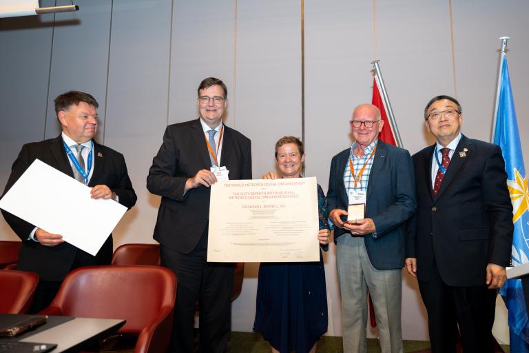 WMO ceremony with certificate and smiling people