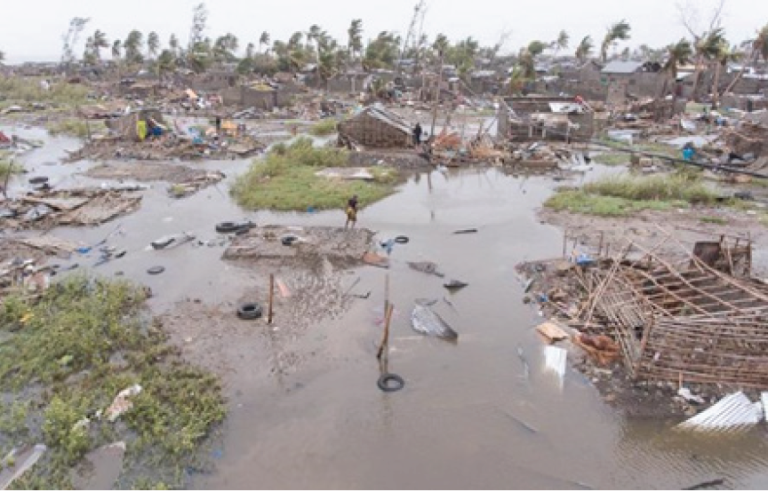 An aerial view of a flooded area with houses and trees.