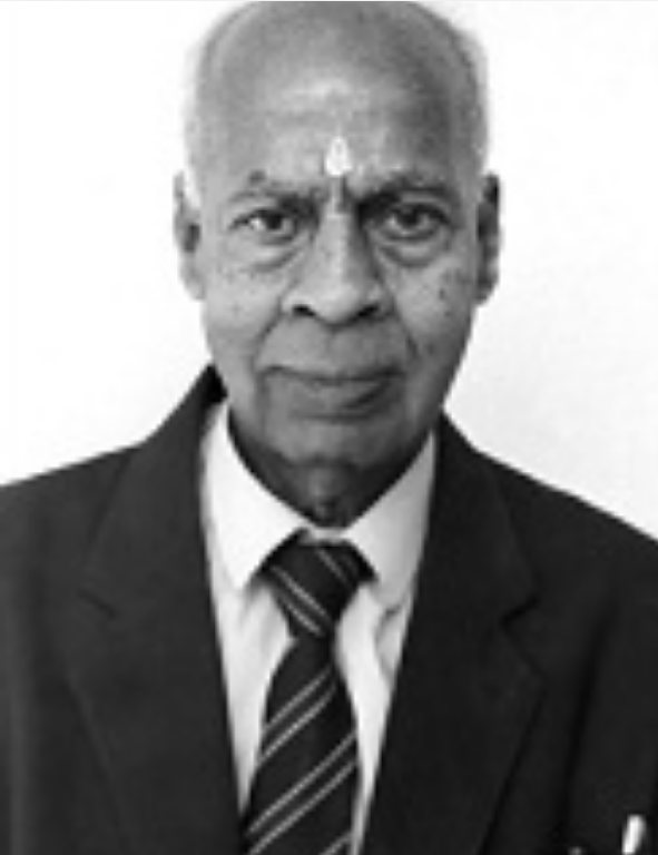 A black and white photo of an older man in a suit.